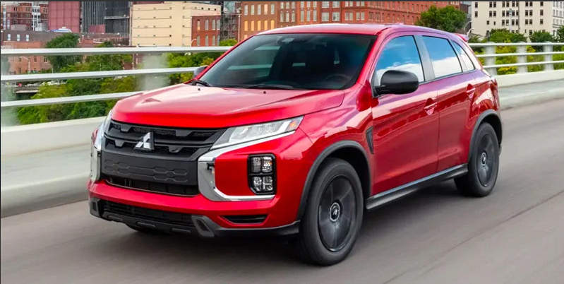 A red 2024 Mitsubishi Outlander Sport driving down the road near Kingsport, TN.