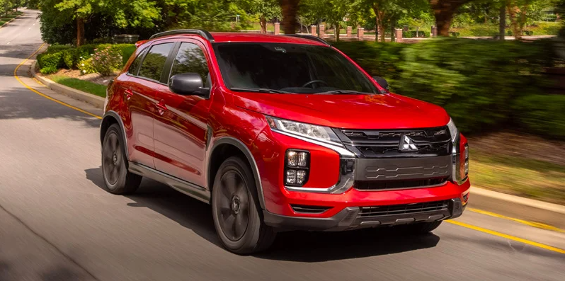  A Red Mitsubishi Outlander Sport driving down the road.