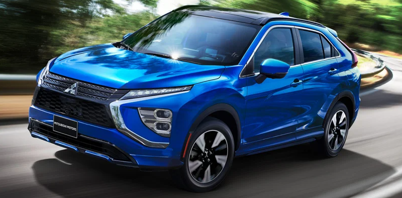 A blue 2025 Mitsubishi Eclipse Cross driving down the road.